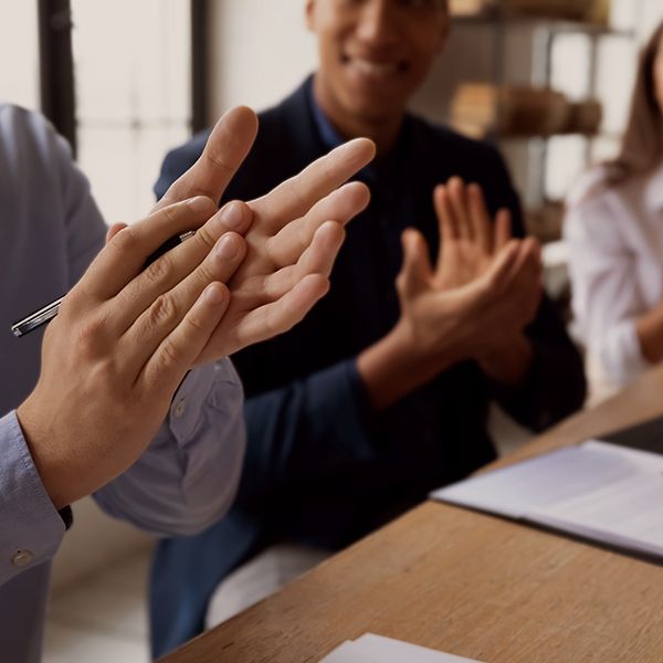 Group of co-workers clapping