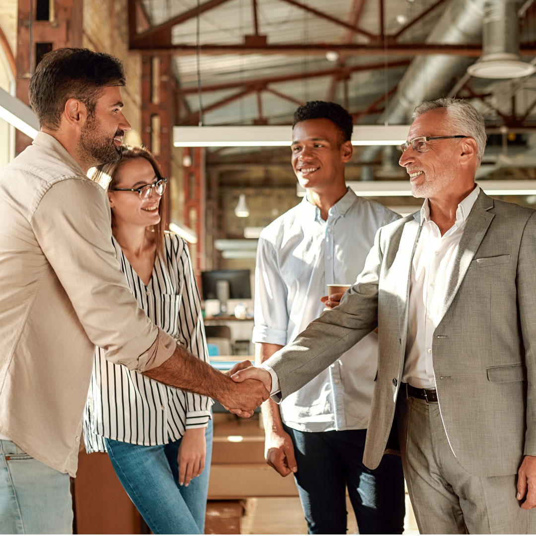 People shaking hands during a business meeting.