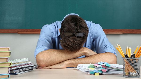 Teacher with head on desk