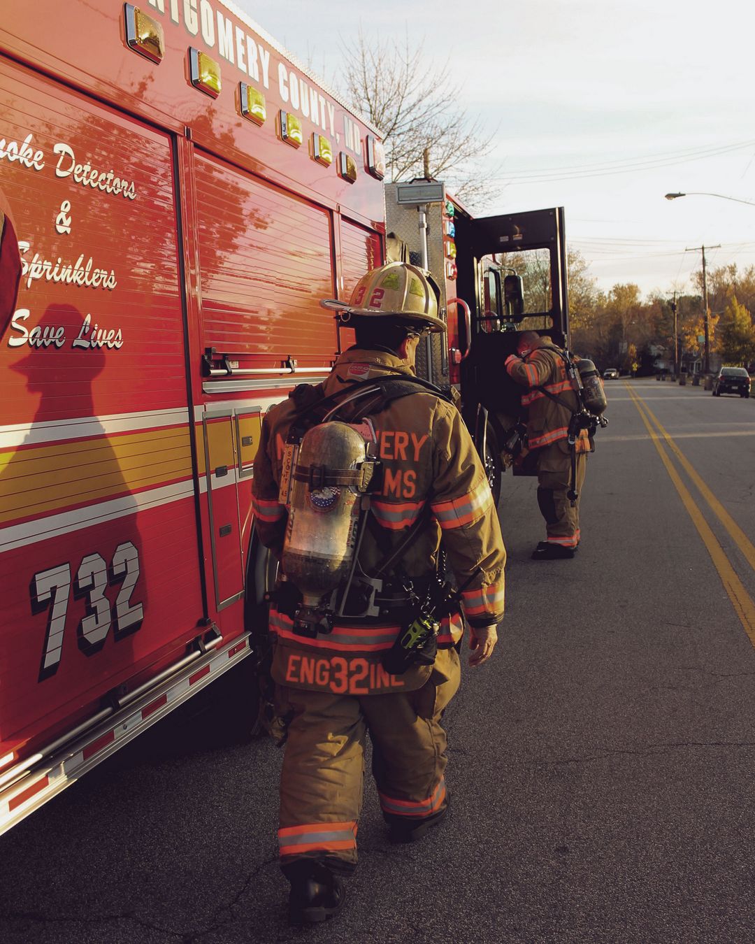 Firefighters alongside fire truck