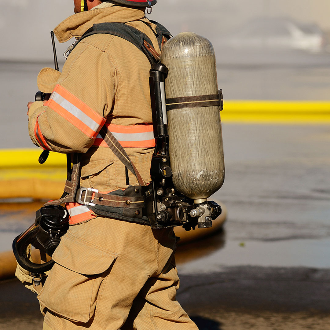 Firefighter walking while wearing all of their gear