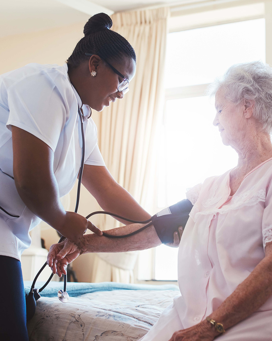 In-home Nurse taking care of elderly patient