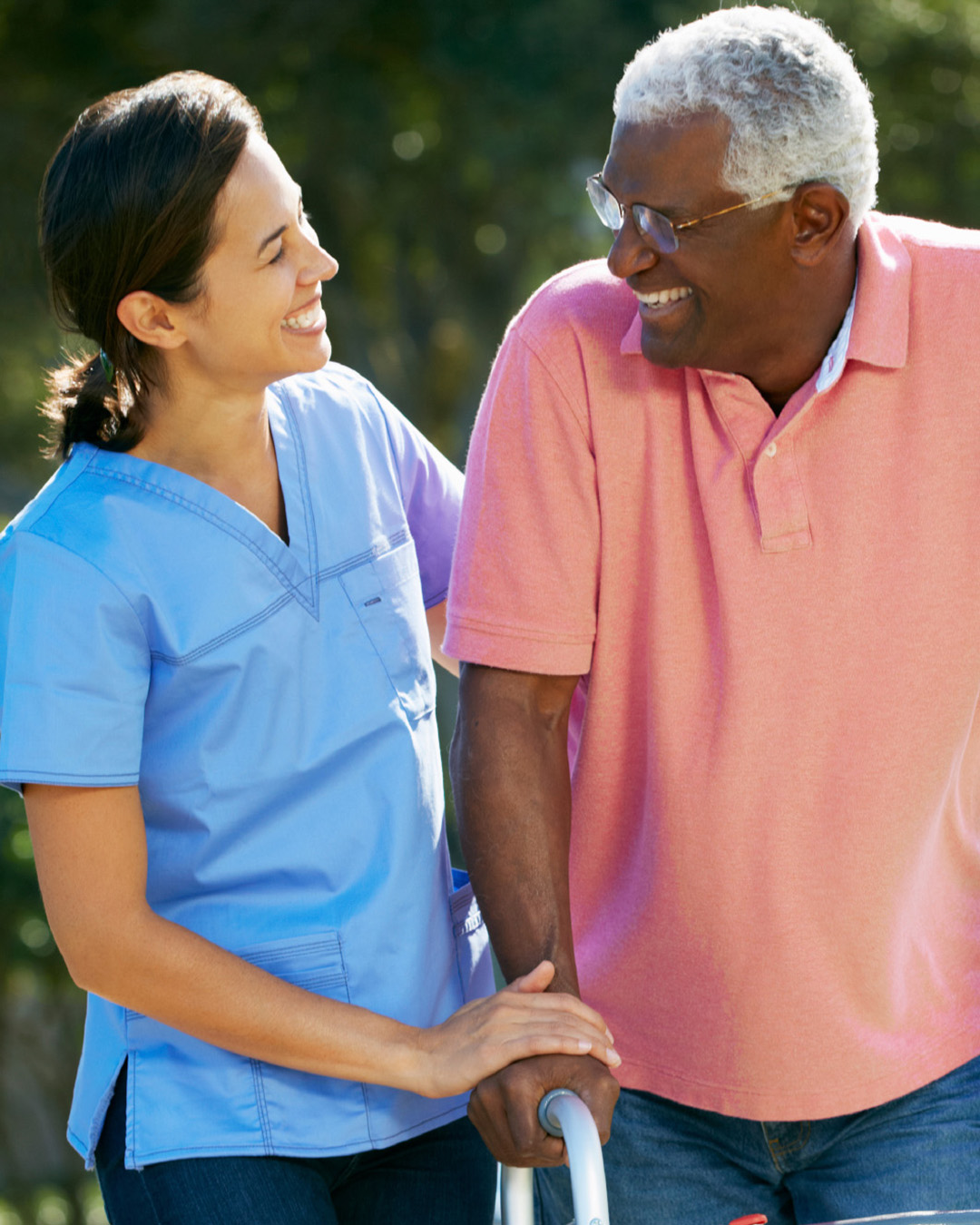 Worker helping older man walk