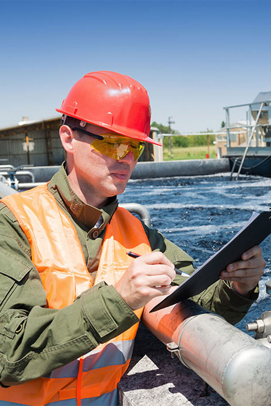A water treatment facility employee performing an inspection