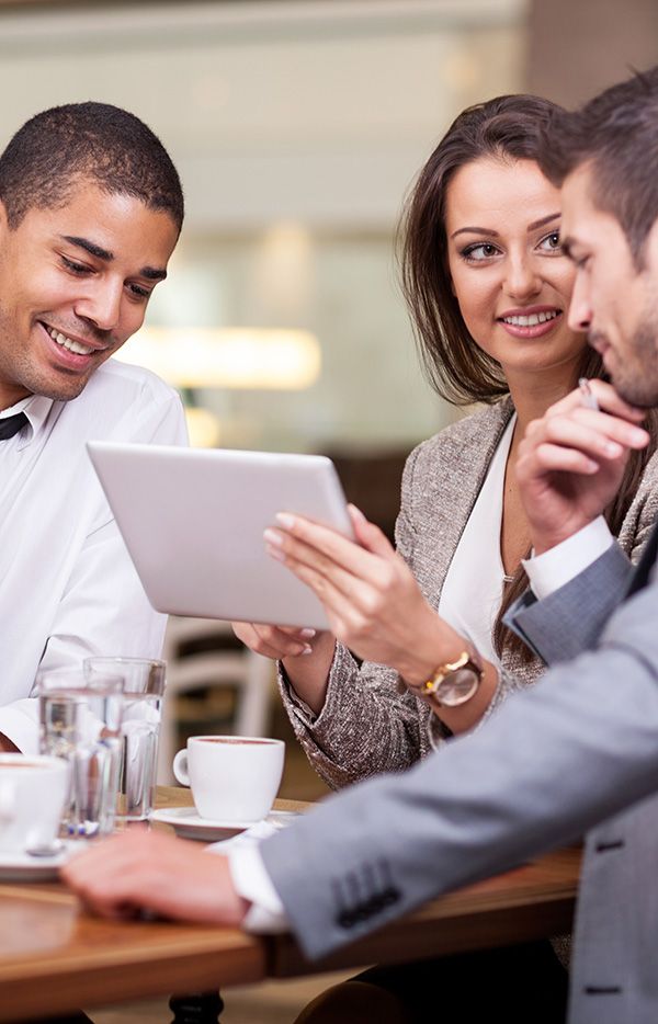 Co-workers looking at tablet