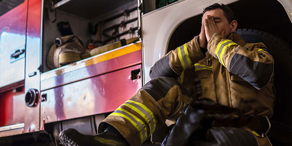 Firefighter sitting, overwhelmed