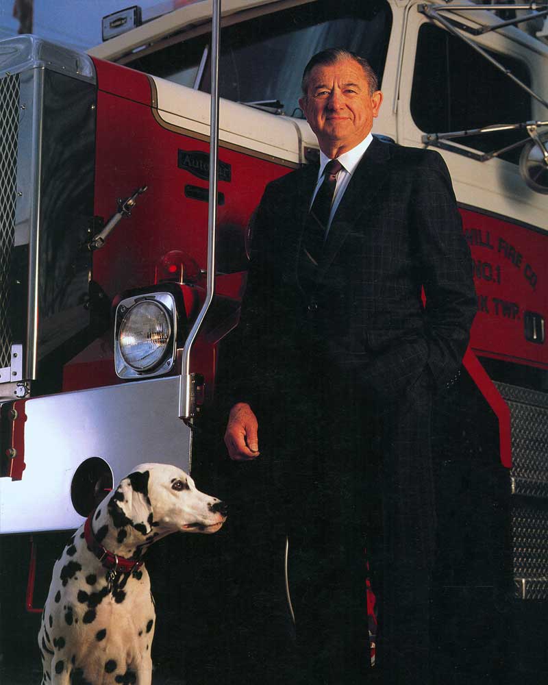 Art Glatfelter standing beside a firetruck